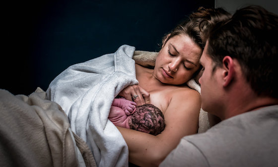 Woman breastfeeding newborn